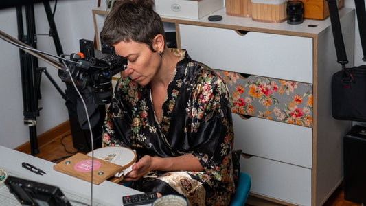 Stella working at her desk in her studio.