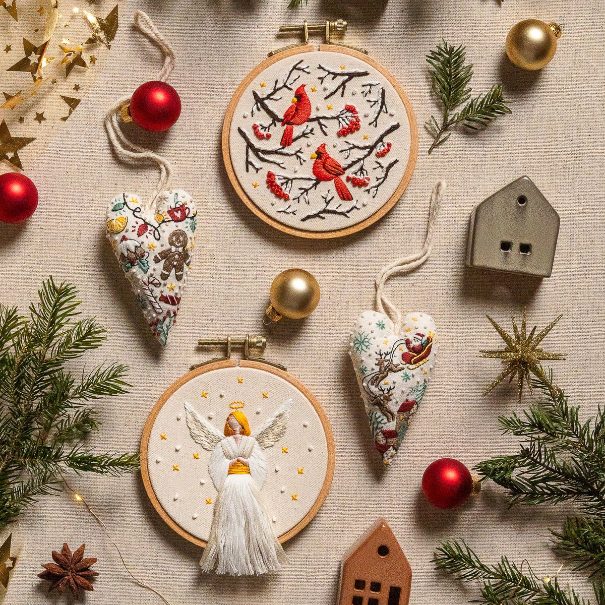 May include: A white embroidery hoop with a hand-stitched design of a candy cane, holly leaves, and a candy. The design is done in red, green, yellow, and white thread.